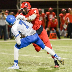 Lahainaluna defensive lineman Nau Filiai (4) puts pressure on Maui High quarterback Austin Hoe (7) late in the game Saturday. Photo by Rodney S. Yap.