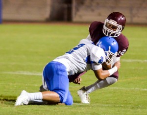 Baldwin quarterback Chayce Akaka is finally brought down by Maui High's Alanai Malafu (2). Photo by Rodney S. Yap.