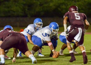 Maui High quarterback Austin Hoe awaits the snap from center Nathan Garduque (57). Photo by Rodney S. Yap.