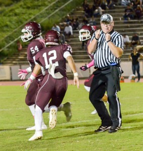 Baldwin's quarterback Chayce Akaka avoids MIL official Mike Simmonds en route to a touchdown run in the first half. Photo by Rodney S. Yap.