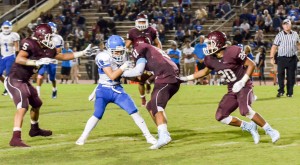 Baldwin's La'akea Kahoohanohano-Davis tries to rip the ball away from Maui High receiver Hunter Hoe (19). Photo by Rodney S. Yap.