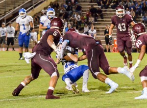 Baldwin's La'akea Kahoohanohano-Davis finishes tackling Maui High's Hunter Hoe. Photo by Rodney S. Yap.