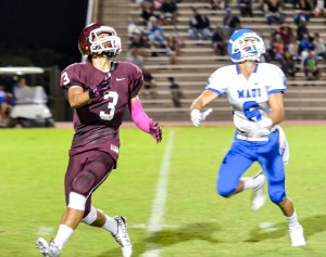 Baldwin's Kaelon Wainui (3) keeps his eye on the ball as Maui High's Nathan Vierra (6) keeps pace. Photo by Rodney S. Yap.