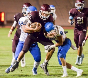 Baldwin's Taje Akaka (2) stays inbounds and works for extra yardage against Maui High's defense Saturday. Photo by Rodney S. Yap.