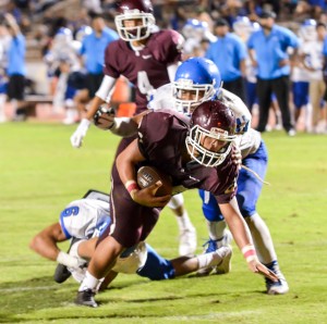 Baldwin's Kamaki Gouveia stays on his feet and lunges for a touchdown after chucking this Maui High would-be tackler. Photo by Rodney S. Yap.