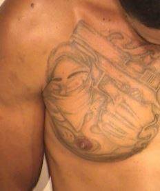 Shaun M. Dennis has the following tattoos: “Gangster holding a gun” on his right chest and “96793” on his right forearm.