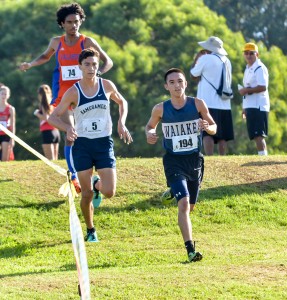 Runner-up boys finisher Louie Ondo of Waiakea runs ahead of Kamehameha's Kaeo Kruse at the beginning of the race Saturday at Seabury Hall. Photo by Rodney S. Yap.
