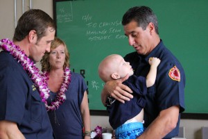 Trucker Dukes with Fire Chief Jeff Murray and his parents to the left. Dec. 14, 2015. Photo by Wendy Osher.
