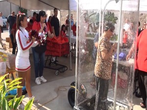 Customers grab cash as fast as they can in KPOA's Money Machine, part of Island Grocery Depot's grand opening celebration. Photo by Kiaora Bohlool.