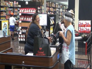 Cashier at Island Grocery Depot in Lahaina. Photo by Kiaora Bohlool.