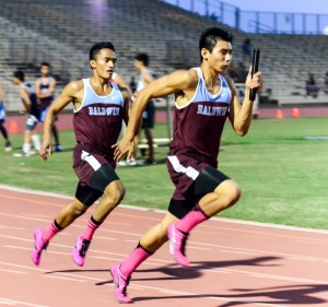 Baldwin's Bailey Kaopuiki takes the baton from Jocel Aquino on the anchor leg of the Bears' winning 4 x 100 relay. Photo by Rodney S. Yap.