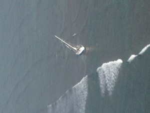 A 43-foot sailboat, Mithrandirs Dream, grounded approximately five miles east of Kaunakakai Harbor, Feb. 5, 2016. A Coast Guard MH-65 Dolphin helicopter crew from Air Station Barbers Point hoisted the two sailors aboard and safely transferred them to Kahului Airport, Maui. (U.S. Coast Guard photo courtesy of Air Station Barbers Point/Released)