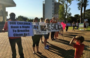 Protesters carrying signs saying "Dept of Health is choking Kids" and "Stop Cane Burning" showed up outside of the State Building today to express their anger at the Department of Health delaying court action on their request for a temporary injunction on cane burning. Courtesy photo.