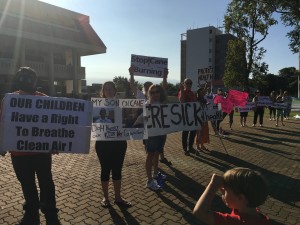 Protesters carrying signs saying "Dept of Health is choking Kids" and "Stop Cane Burning" showed up outside of the State Building today to express their anger at the Department of Health delaying court action on their request for a temporary injunction on cane burning. Courtesy photo.