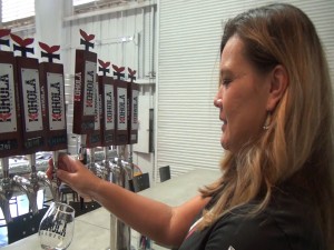 Christine Elumba works the taps at Koholā Brewery in Lahaina. Photo by Kiaora Bohlool.