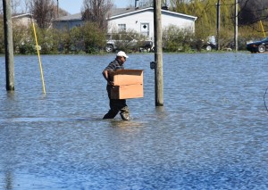 March 13, 2016. Robinsonville, Mississippi. American Red Cross client assistance teams canvassed areas of North Mississippi (Tunica County) that were affected by floodwaters. Robinsonville, Mississippi, resident Elvin Moore heads for his now flooded home with cleanup kits provided by the American Red Cross. Photo by Bob Wallace/American Red Cross