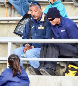 Kamehameha Maui head coach Ruby Huber (top left) and assistant coach Jason Bisera talk to one of their jumpers on the sidelines. Photo by Rodney S. Yap.