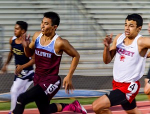 Seabury Hall's Isaiah Payne pulls along side Baldwin's Bailey Kaopuiki in the boys 200-meter dash Saturday. Photo by Rodney S. Yap.