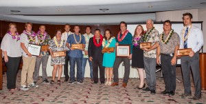 2016 Small Business Award Winners photo, Maui County: (left to right) Teena Rasmussen; Dennis and Shaun Walsh of Skullbase; Caroline Killhour of Hui No‘eau Visual Arts Center; Cody Christopher, Travis Morrin and Jaron Blosser of Three’s Catering LLC dba Three’s Bar & Grill; Mayor Alan Arakawa; Cheryl and Michael Rock of Mele Ukulele; Pam Tumpap; David Tucker and Robert Campbell of Maui Printing Company Inc.; and Jonathan Miller of eDesign Group, Inc.