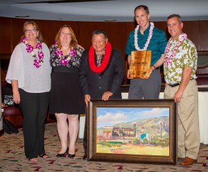 Mayor’s Office of Economic Development Directo Teena Rasmussen; Maui Chamber of Commerce President Pamela Tumpap and Mayor Alan Arakawa present the Legacy Award for Small Business Support to HC&S. (Second from right) Alexander & Baldwin President & CEO Christopher Benjamin and (far right) HC&S General Manager Rick Volner also received an original oil painting by artist Michael Clements. Maui County photo.