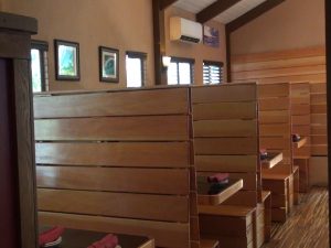 Wooden benches at Three's were crafted by the three owners. Photo by Kiaora Bohlool.