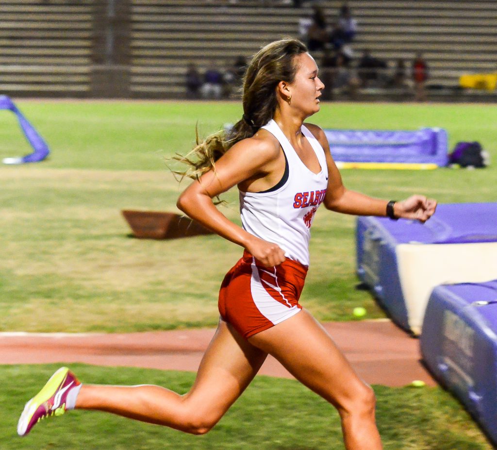 Seabury Hall's Ava Shipman runs to the finish line of the girls 3000 run Saturday. Photo by Rodney S. Yap.