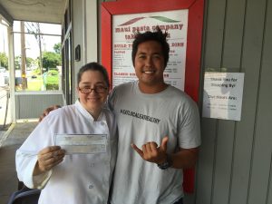 Patricia Inman with Maui Pasta Company accepts a check from Three's and its Kama‘āina Give Back Program. Courtesy photo.