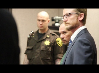 Stephen Schmidt (center) is accused of stabbing his estranged wife in a confrontation at the Kehalani Foodland on April 19, 2016. He is flanked by security (left) and his defense attorney Samuel MacRoberts (right). Photo (4.25.16) in Wailuku District Court.