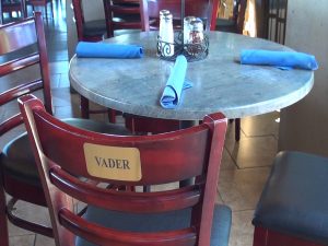 Custom plaques on the bar stool's at Manoli's Pizza Company in Wailea. Photo by Kiaora Bohlool.