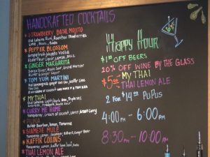 Cocktails and happy hour board at The Brasserie. Photo by Kiaora Bohlool.
