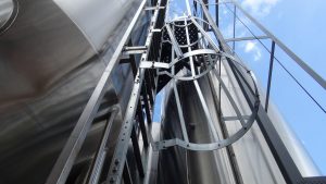 Huge fermentation tanks outside the brewery. Photo by Kiaora Bohlool.
