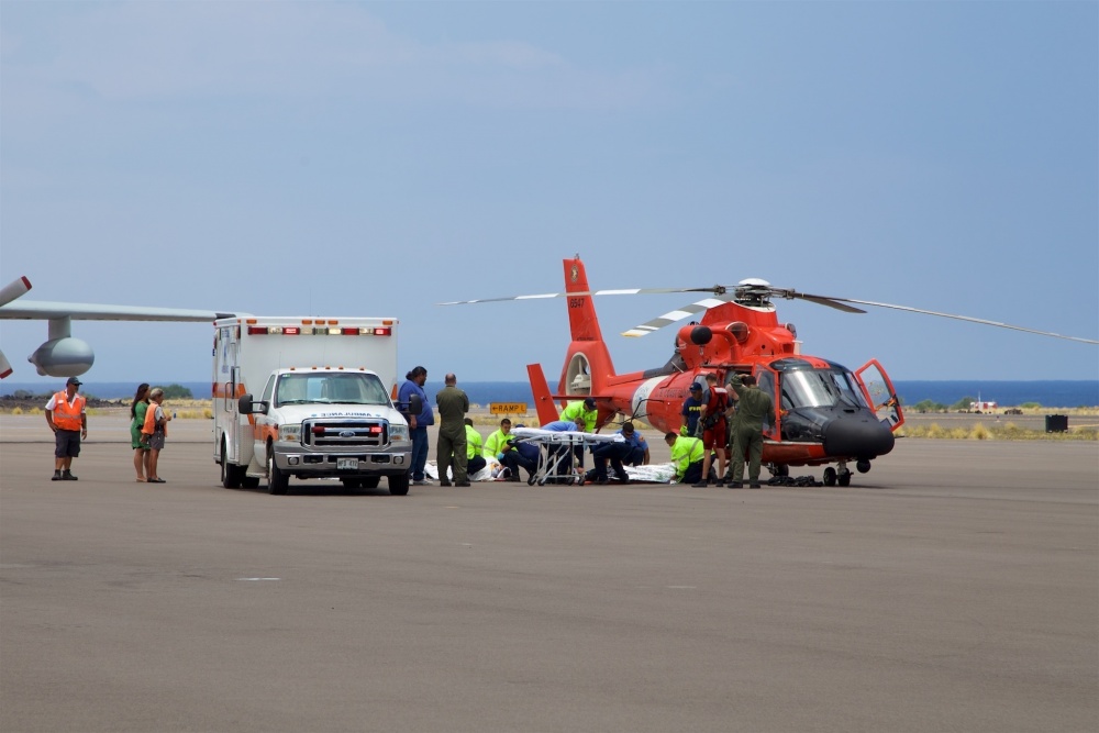 Coast Guard crews safely deliver David McMahon and Sidney Uemoto to emergency medical personnel in Kona, Hawaii, July 15, 2016, following their rescue nine miles off Kona. They were both rescued by a Coast Guard MH-65 Dolphin helicopter crew following an expansive joint search by Navy, Royal New Zealand air force, U.S. Air Force and Coast Guard crews. They reportedly sustained only minor injures in the crash. (U.S. Coast Guard photo by Lt. Cmdr. Kevin Cooper/Released)
