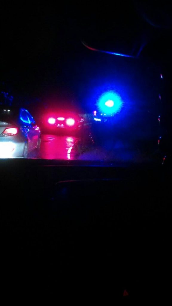 A polcie officer blocked off the town bound lane of traffic by the contraflow stop lights due to a landslide at 9:10 p.m. on Saturday, Sept. 3, 2016. Photo credit: Kristi Souza