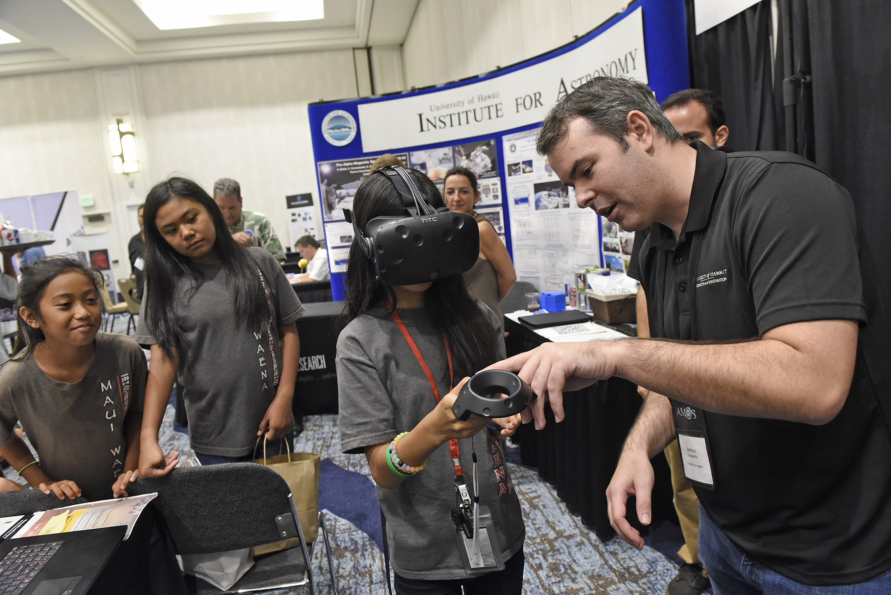 Students explored SSA data in an immersive experience of orbits of a wide variety of satellites. These satellites make a big impact on the community and in the world for national security, internet, banking, telephones, television, navigation, scientific exploration and more. Pictured (L-R) are: Maui Waena students Glenzy Salcedo, Samantha Della and Emily Tom, and Andrew Guagliardo, Undergraduate, LAVA program, UH Mānoa.