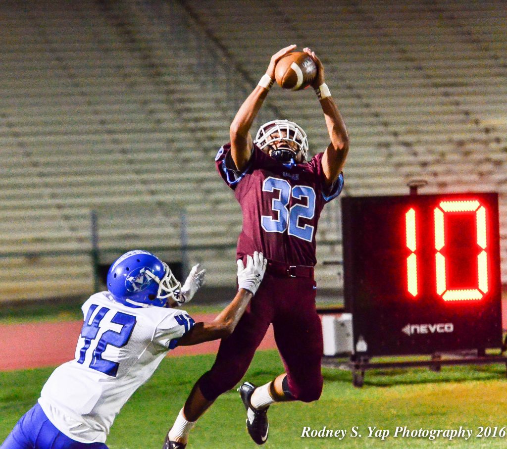 Baldwin's Kainalu Lacno goes up for this 27-yard touchdown catch in the third quarter against Maui High on Monday. Defending on the play is Maui High's Tevita Takitaki Jr. (42). Photo by Rodney S. Yap.