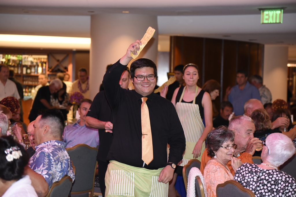 Former St. Anthony Junior-Senior High School Student Body President Micah Leval (center), a 2016 alum, seeks support from attendees during the 2015 Strength in Unity Gala at the Kamehameha Golf Clubhouse. Funds raised at this year’s event set for Friday, November 11, will go towards student tuition assistance.
