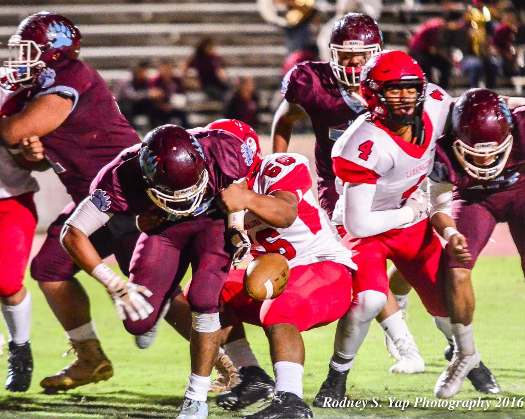 Lahainaluna's Viliami Hafoka rips the football out of the hands of Baldwin quarterback Chayce Akaka near the goal line Saturday at War Memorial Stadium. Photo by Rodney S. Yap.