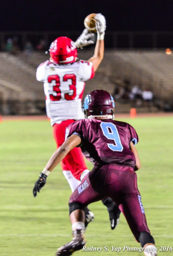 Lahainaluna's Joshua Tihada could not hang on to this pass as Baldwin's Damien Defrancia closes in to break up the play. Photo by Rodney S. Yap.