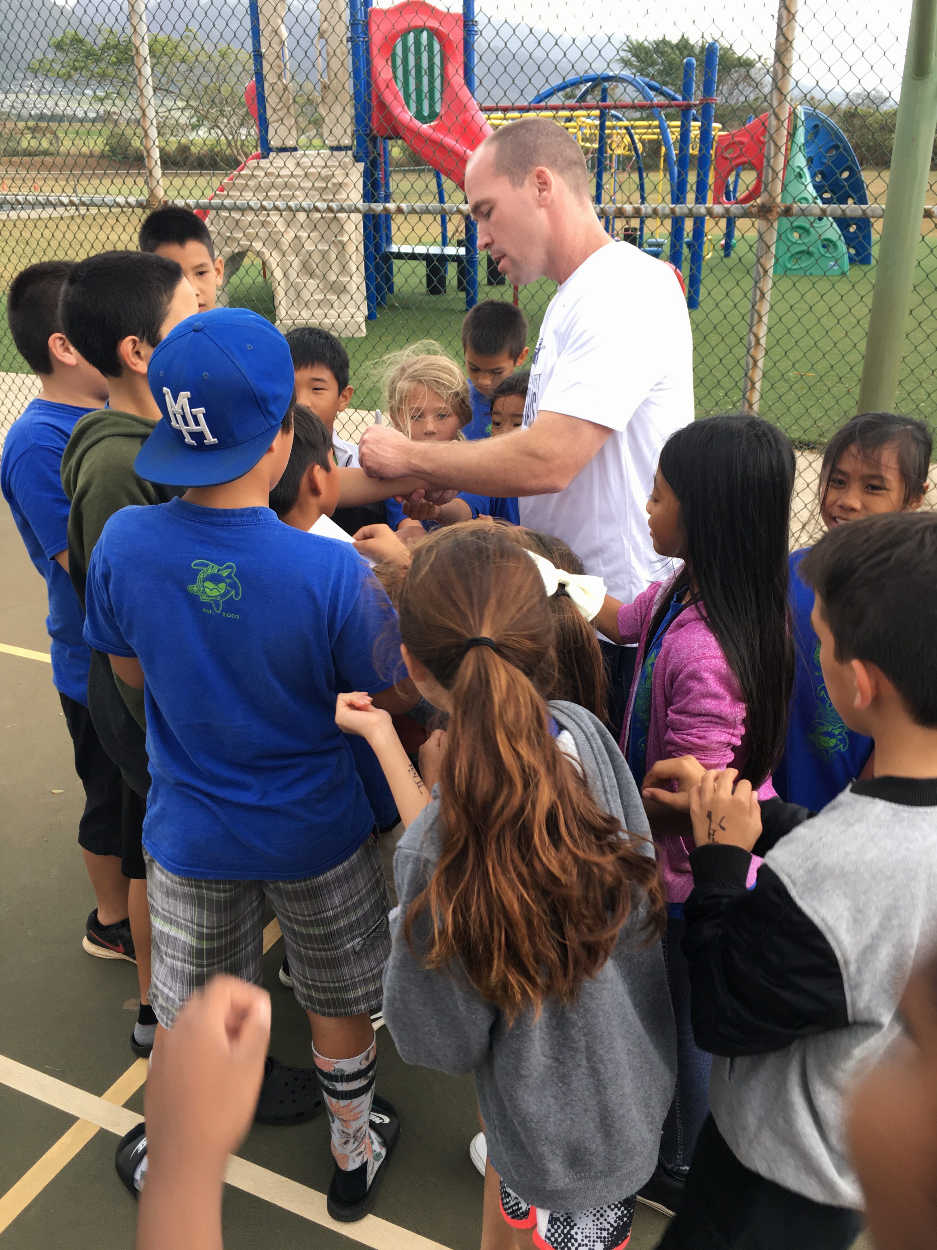 BYU visit to Pōmaikaʻi Elementary head coach Jeff Judkins signing autographs. PC: basketballMAUI