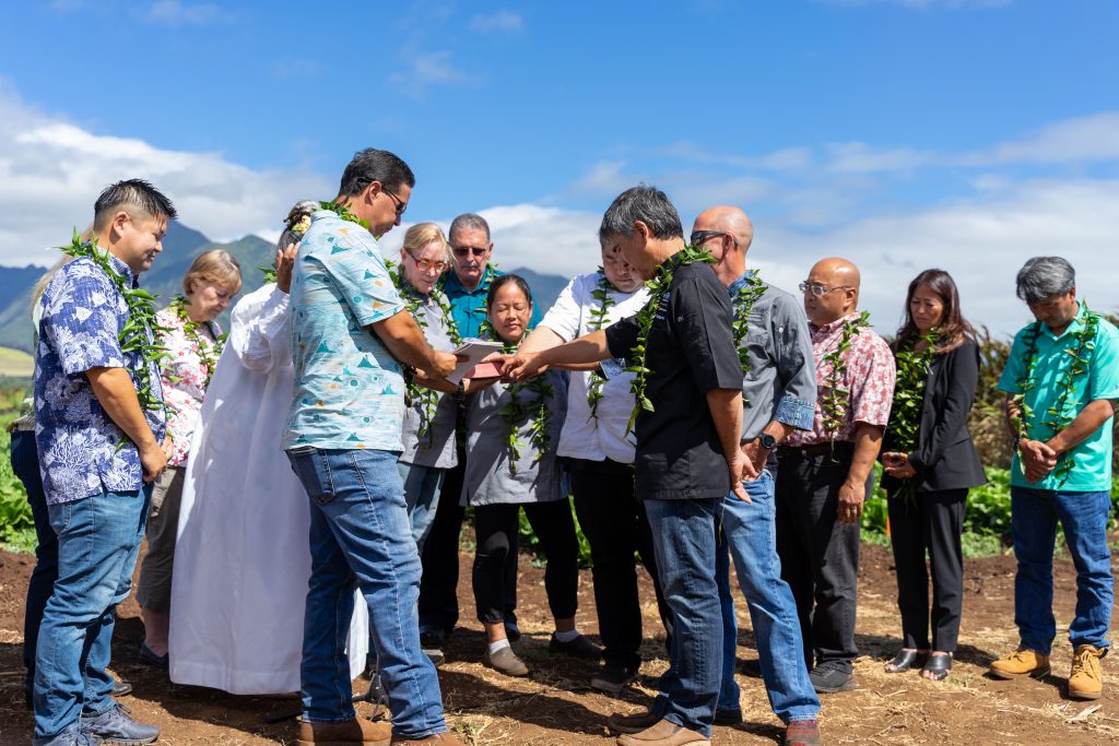 Chefs and executives surrounded a bible as three prayers were recited in Hawaiian Thursday morning. Photo by JD Pells.