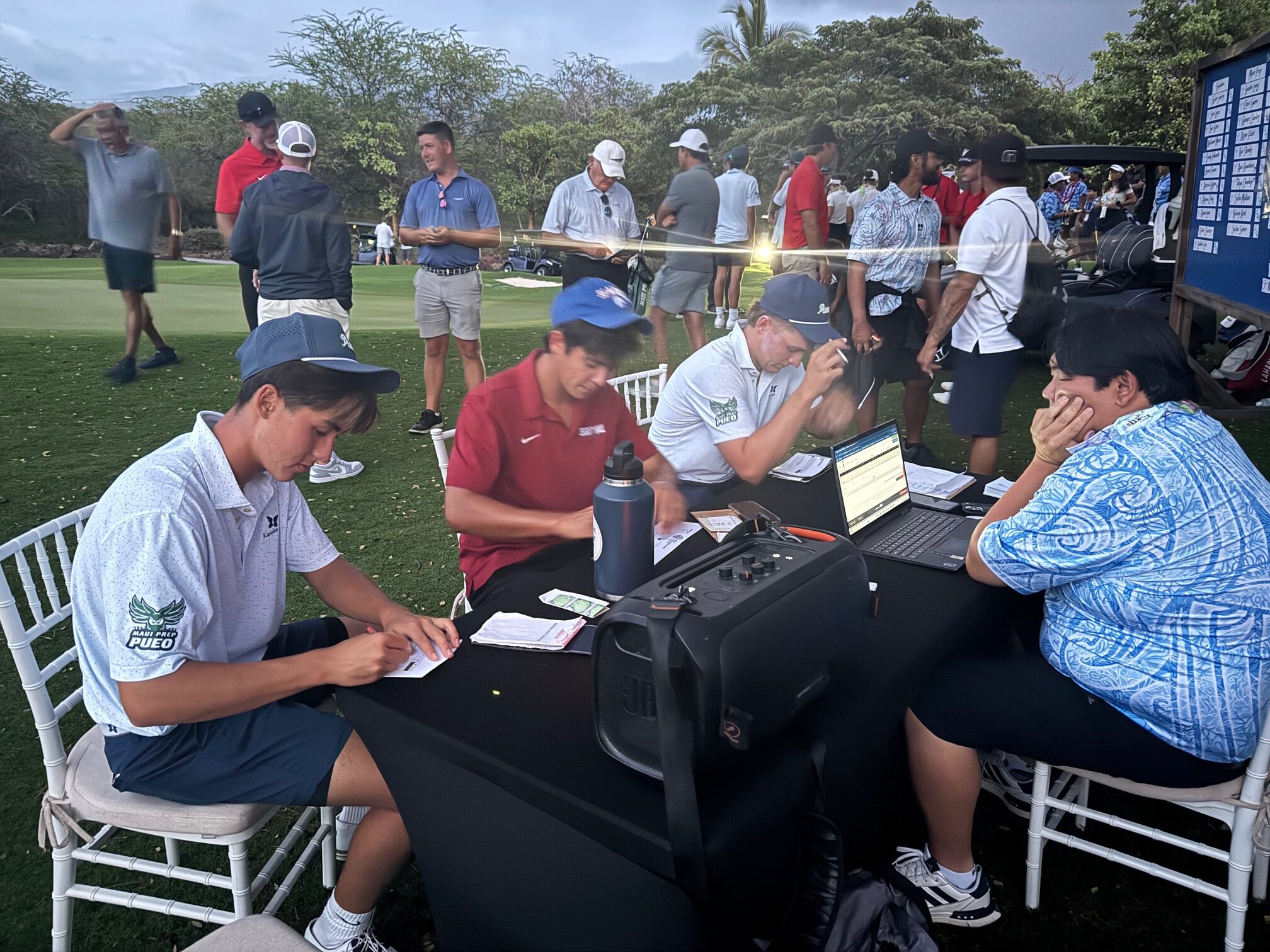 The final group at the Maui Interscholastic League individual golf tournamwnt -- Chris Salem, Tyler Loree and Landon Long -- sign their cards on Tuesday at Makena Golf and Beach Club. HJI / ROB COLLIAS photo