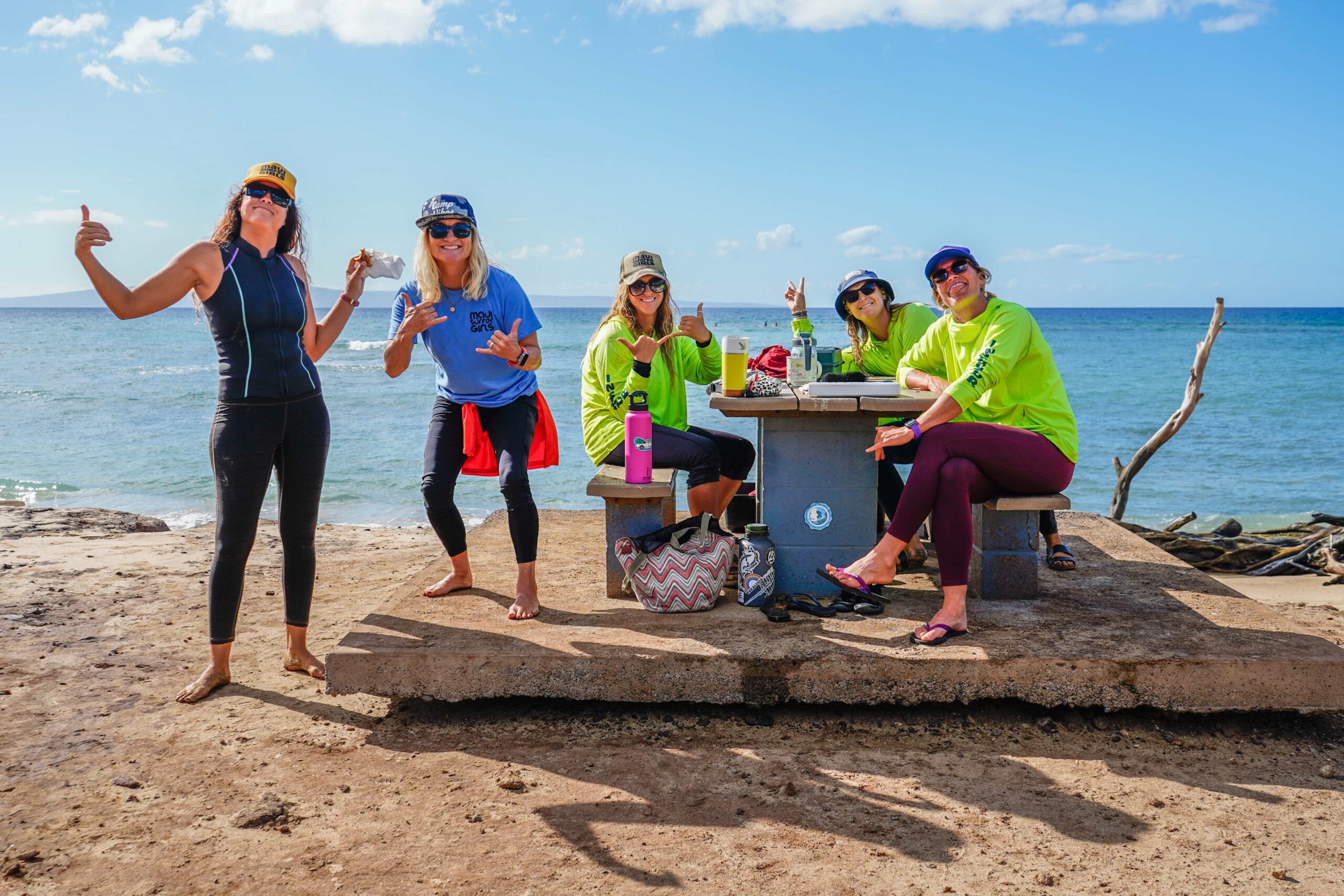 The staff of Maui Surfer Girls, founded by Dustin Tester (blue shirt) 25 years ago, takes a break recently at Ukumehame Beach Park. @rachaelzimmermanphotography photo