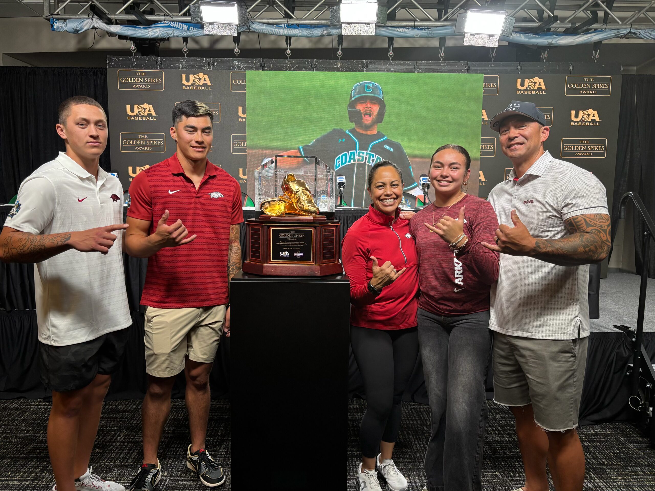 The Aloy family stands next to the Golden Spikes Award that Wehiwa Aloy, a 2022 Baldwin High School graduate, won on Saturday as a member of the University of Arkansas baseball team. The award goes to the best amateur baseball player in the country. From left, younger brother Kuhio Aloy, Wehiwa Aloy, mom Napua Aloy, little sister Kiani Aloy and dad Jamie Aloy are all smiles. Courtesy photo