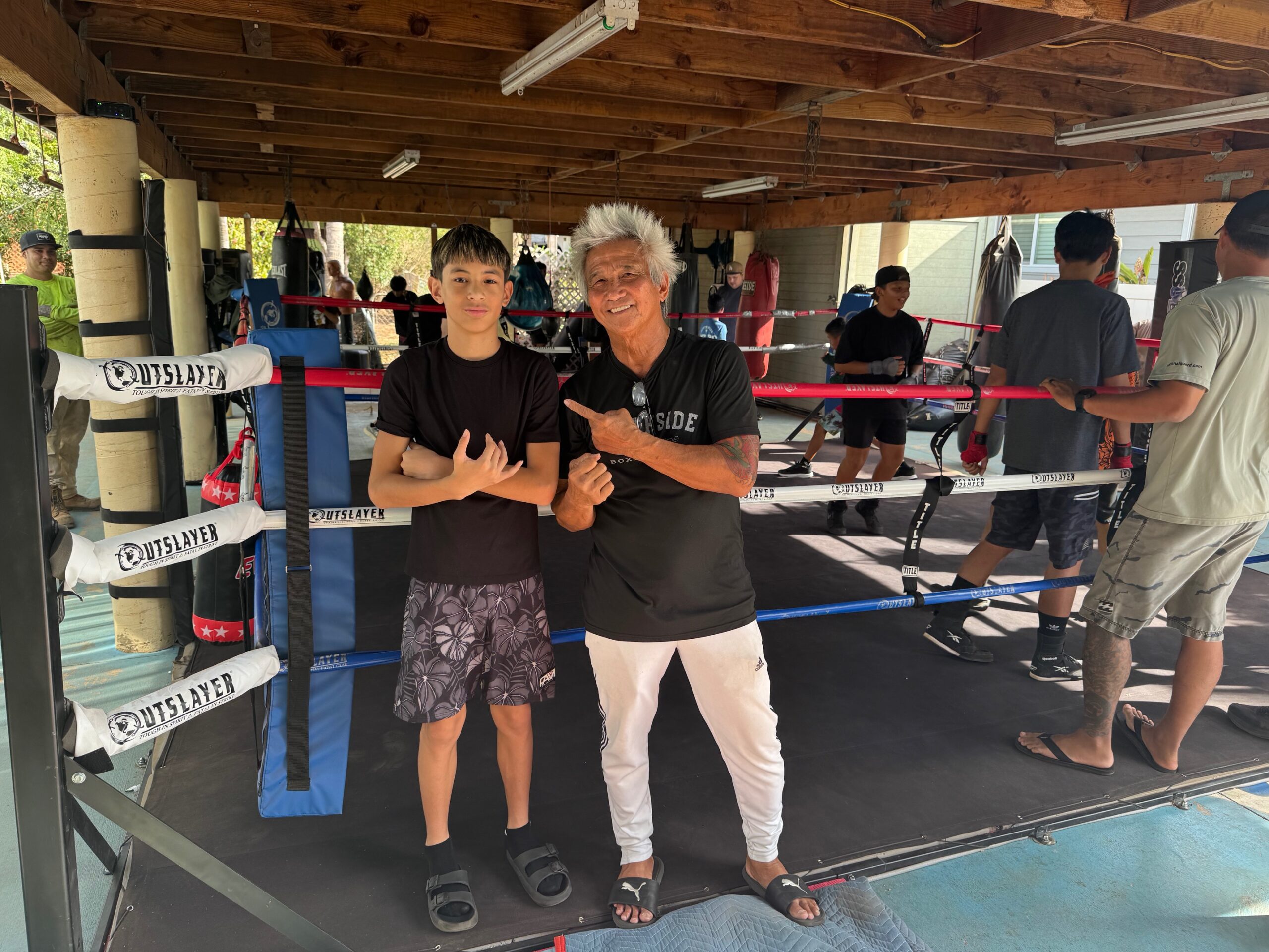 Micah Diaz, a 13-year-old who will be in eighth grade at Lokelani Intermediate School in the fall, won the USA Boxing Junior Olympic title in his 90-pound intermediate division, finishing a 4-0 run on June 20 in Las Vegas, Nevada. He is on the left here, with South Side Boxing Club coach Nante Manangan. HJI / ROB COLLIAS photo