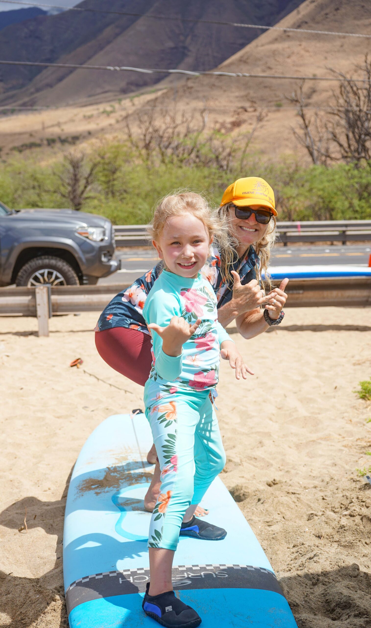 Leilani Wood, a 7-year-old, prepares for a surf lesson with Maui Surfer Girls founder in September 2024 at Ukumehame Beach Park. Jungle Rootz Hawai'i photo