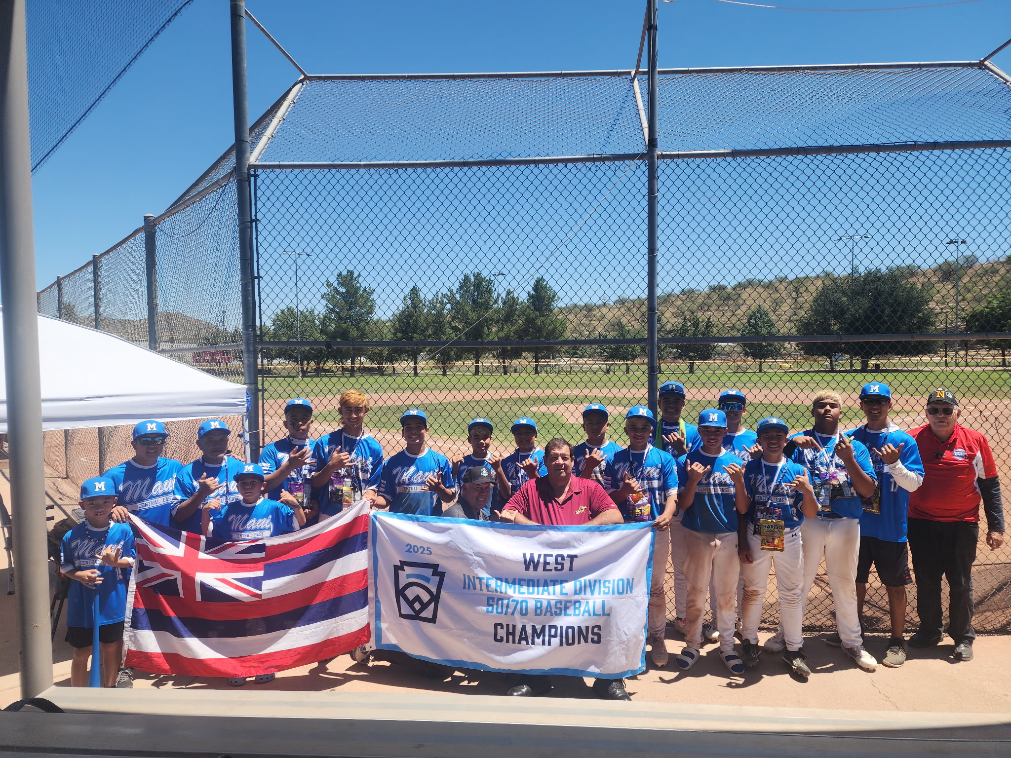 The Central East Maui Little League All-Stars and supporters show off their championship banner from the West Region Intermediate 50/70 Division on Thursday in Nogales, Ariz. The victory advanced the Maui team to the Intermediate World Series in Livermore, Calif., that runs through Aug. 3. Courtesy photo