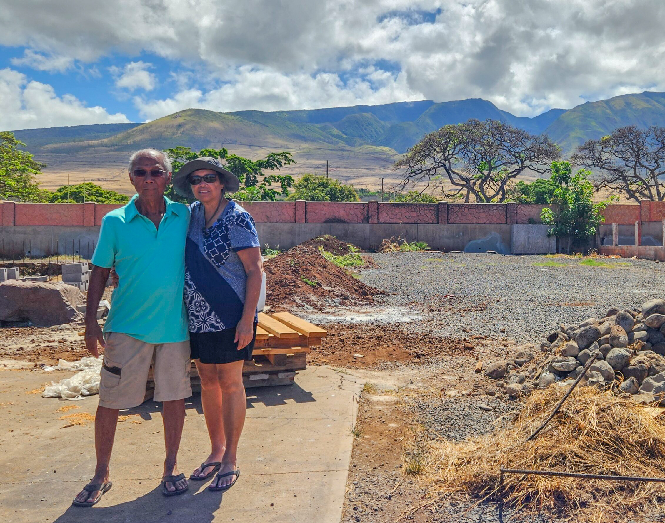 Kelcy Durbin's parents Juan and Frances Asuncion stand on their Wainee Street lot in Lahaina during a pre-construction blessing in June. Photo courtesy: Kelcy Durbin