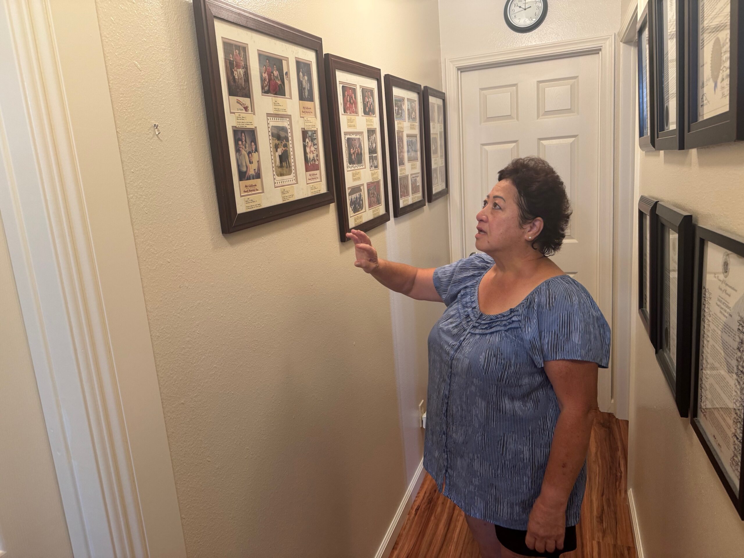 Joycelyn Victorino looks at family photos in her Wailuku Heights home on Thursday. HJI / ROB COLLIAS photo