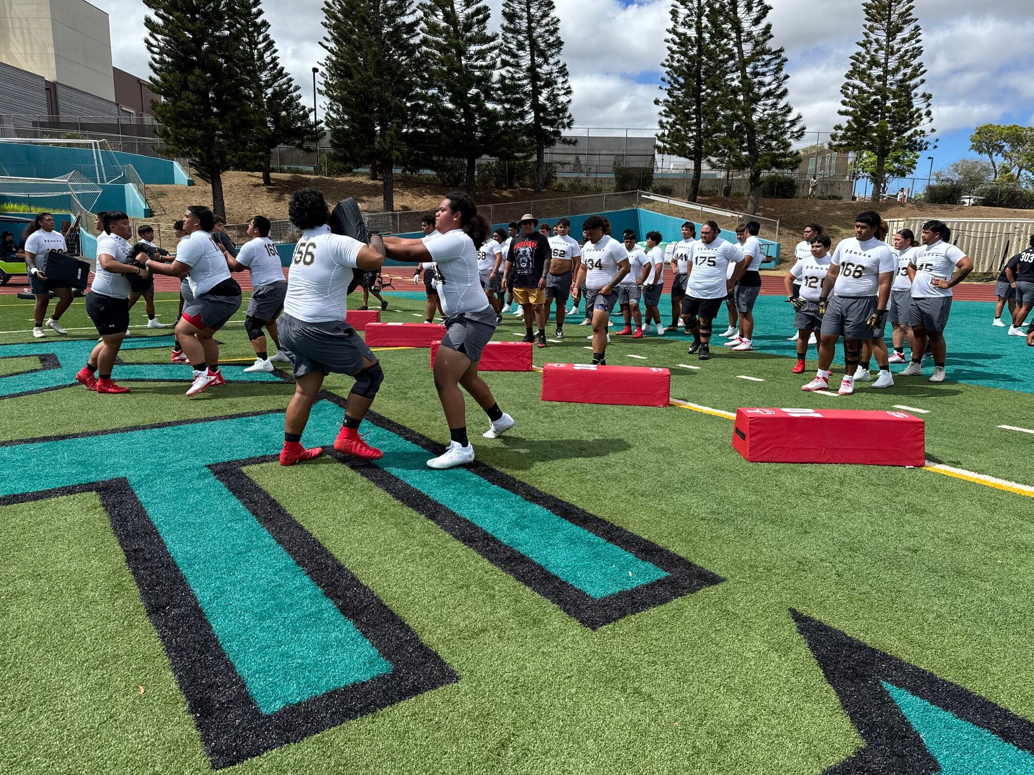 Lahainaluna High School junior offensive lineman David Kauvaka (forefront, right) battles in a one-on-one drill at the Under Armour Next Camp on Saturday at King Kekaulike Stadium. HJI / ROB COLLIAS photo