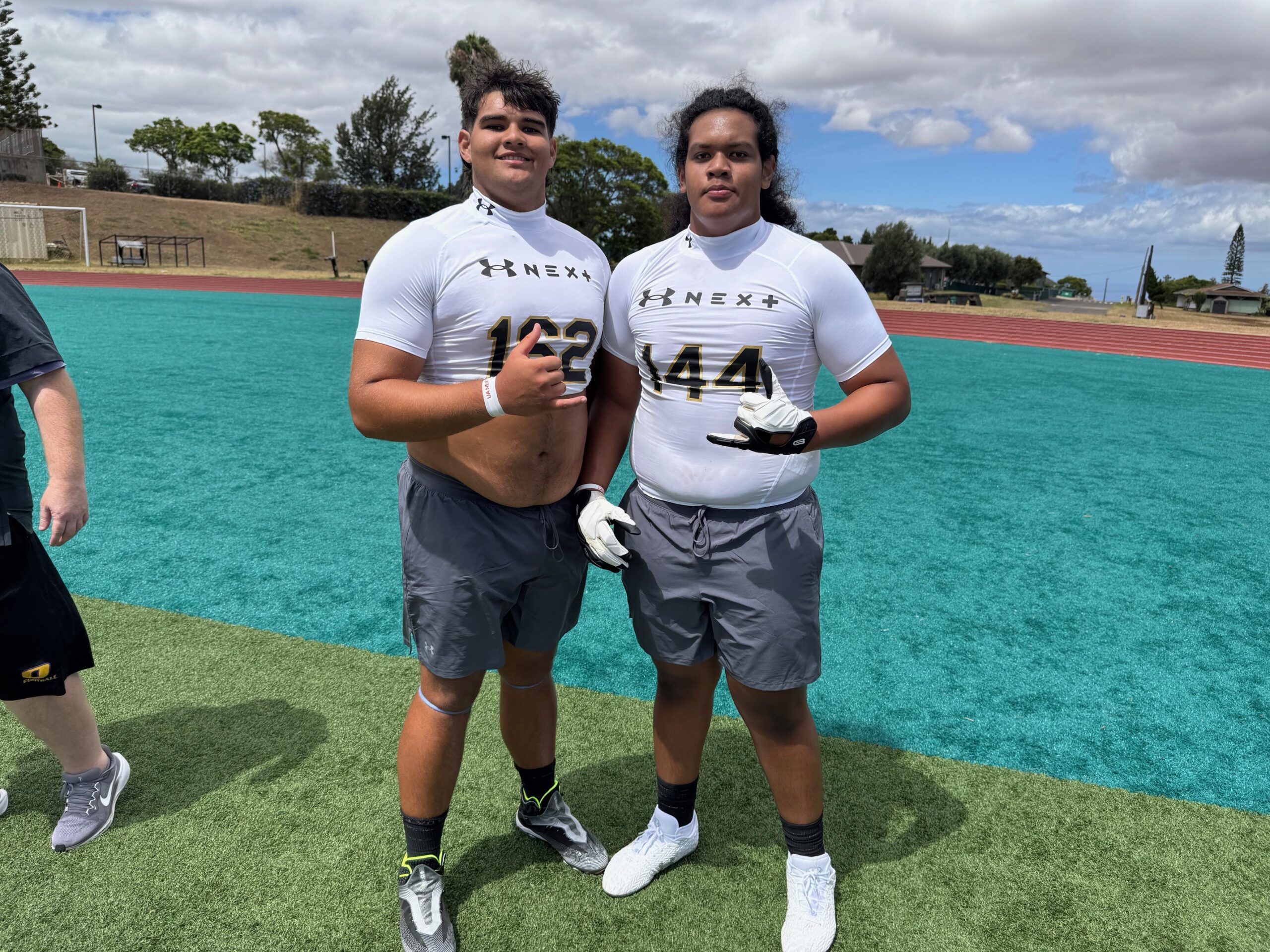 Two of the top college prospects in the Maui Interscholastic League, Pa'u Spencer of Kamehameha Maui (left) and David Kauvaka of Lahainaluna, stood out in offensive line drills on Saturday at the Under Armour Next Camp at King Kekaulike Stadium. HJI / ROB COLLIAS photo